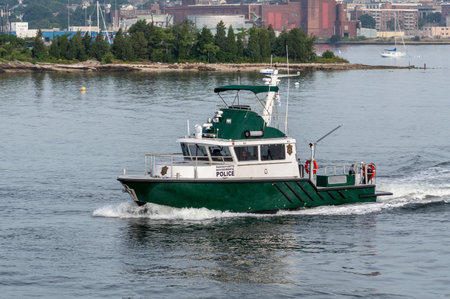 New Bedford, Massachusetts, USA - July 31, 2018: Massachusetts Environmental Police patrol boat crossing New Bedford inner harborのeditorial素材