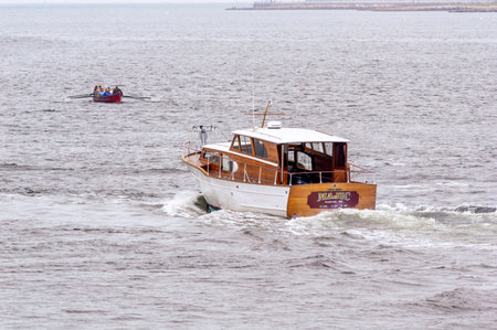 New Bedford, Massachusetts, USA - June 24, 2018: Yacht Majic, hailing port Aquinnah, MA, passing whaleboat on her way toward foggy Buzzards Bayのeditorial素材
