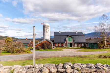 New Hampshire, USA - October 2, 2009: Farm in the foothills of the White Mountains under broken clouds on autumn dayのeditorial素材