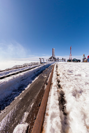 Mount Washington, New Hampshire, USA - October 2, 2009: Slushy tracks as sun begins to melt new snow at summit of Cog Railway run up mountainのeditorial素材