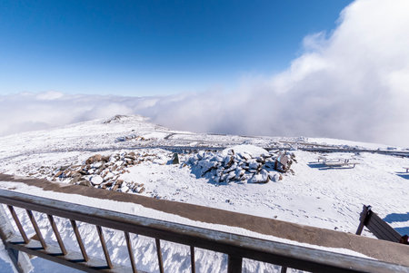 Automobile road and cog railway tracks disappear downhill from summit of Mount Washingtonのeditorial素材