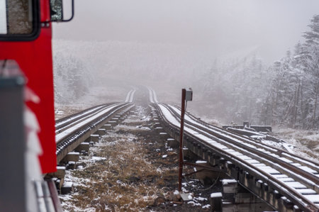 Mount Washington, New Hampshire, USA - October 2, 2009: Cog Railway train inches its way up the steep mountain after the first snowfall of the seasonの写真素材
