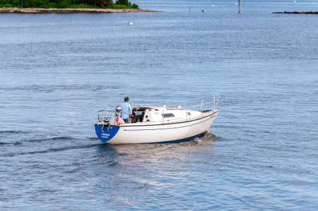 New Bedford, Massachusetts, USA - July 7, 2020: Men bringing demasted sailboat I Wonder into New Bedford inner harborのeditorial素材