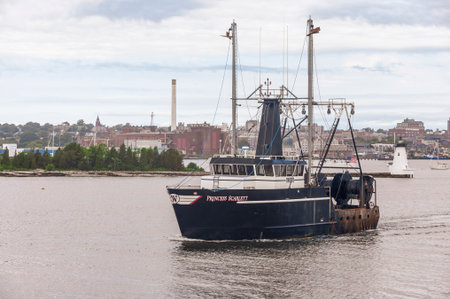 New Bedford, Massachusetts, USA - July 11, 2020: Commercial fishing boat Princess Scarlett, hailing port Cape May, New Jersey, passing lighthouse in New Bedford harborのeditorial素材