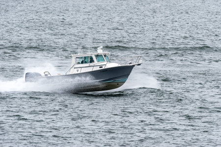 Fairhaven, Massachusetts, USA  - April 28, 2019: Powerboat hopping across choppy water in New Bedford outer harborのeditorial素材