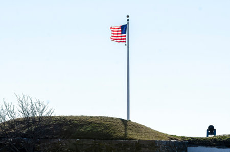 Fairhaven, Massachusetts, USA - March 14, 2020: American flag snapping in breeze on morning in late winter at Fort Phoenixのeditorial素材