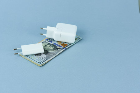 paper bills and chargers for phones and tablets. moneyの写真素材
