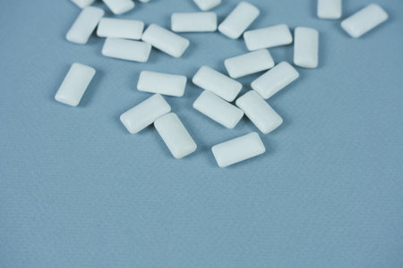 Chewing gum close-up on blue background with space for text.の写真素材