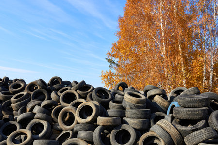 Novosibirsk, Siberia, Russia - October 17, 2021. Old discarded car tires. The concept is environmental pollution.のeditorial素材