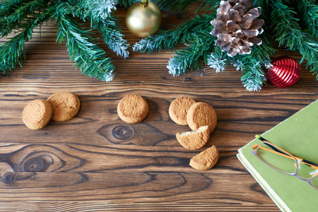 New Year's Eve background with cookies, book and glasses. Concept - nice cozy evenings with your...