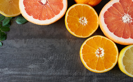 Citrus fruit halves with blank space for text. The concept is cold season, vitamin C.の写真素材