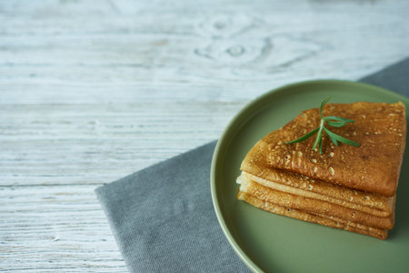 Pancakes on a green plate, with room for text. A national dish of different peoples of the world.の写真素材