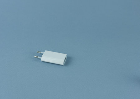 Phone charger on blue background.