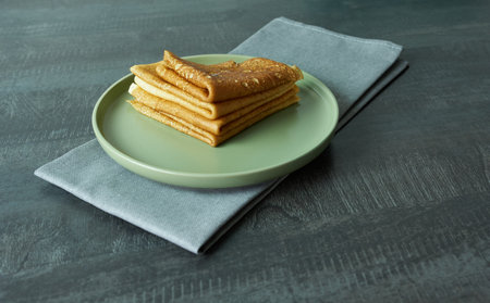 Plate with stack of pancakes on gray wooden table, closeupの写真素材