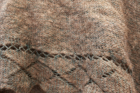 Vintage knitted wool shawl with pattern. Ornament of the shawl close-up.