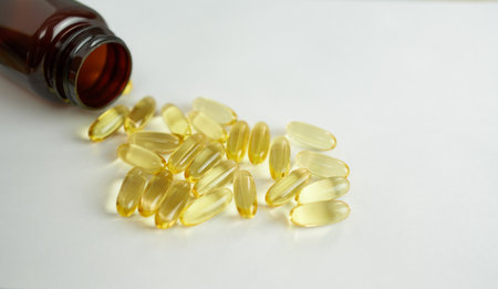 Fish oil capsules on white background with copy space for your text.