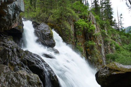 A waterfall in the mountains of the Altai Mountains. beautiful nature.