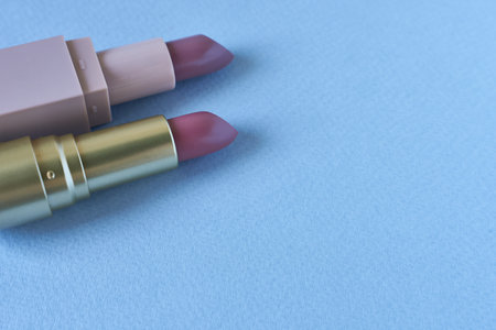 Lipsticks on a blue background with copy space for text.の写真素材