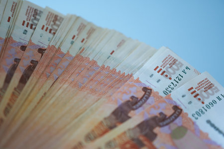 Close-up of Russian money banknotes on blue background.