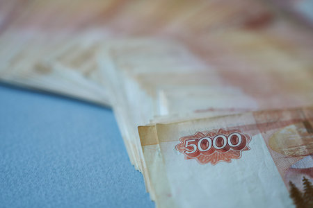 Close up of banknotes of 5000 rubles on a blue background