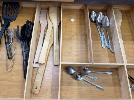 Kitchen utensils in a wooden drawer. Close up.の写真素材