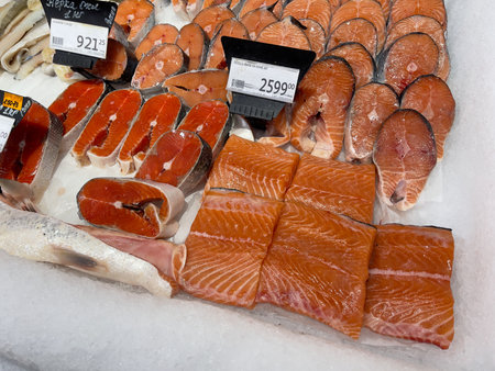 Novosibirsk, Siberia, Russia - November 11, 2023. Sliced salmon and other fish on ice in the supermarket. Supermarket, Auchanのeditorial素材