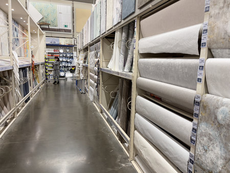 Novosibirsk, Siberia, Russia - November 18, 2023. Interior of a modern construction store with rows of wallpaper rolls. Wallpaper for walls.のeditorial素材