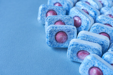 Dishwasher tablets on a light blue background. Copy space.の写真素材