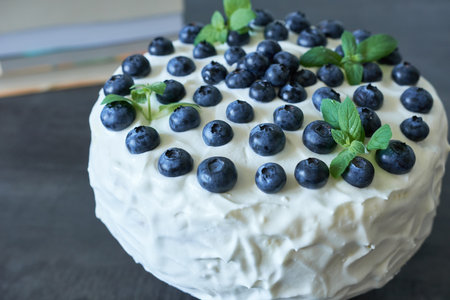 Delicious cake with blueberries and mint on table, closeupの写真素材