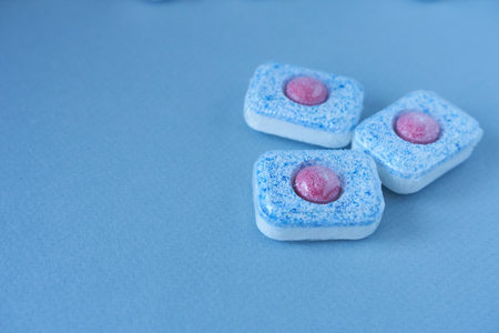 Dishwasher detergent on a blue background. Small depth of field.の写真素材