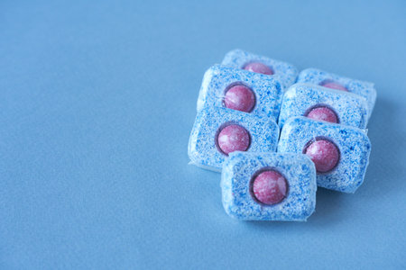 Blue and pink items on a blue background. Copy space for text.の写真素材