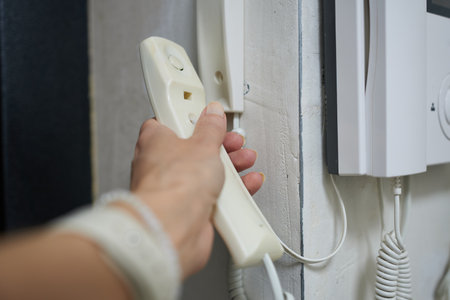 Close-up of a person's hand inserting a cord into the wall