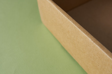 Cardboard box on a green background. Close-up. Selective focus
