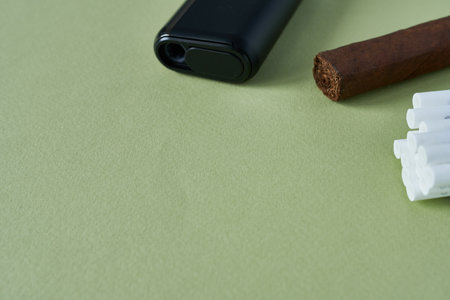 Cigar and electronic cigarette on green background. Close-up.の写真素材