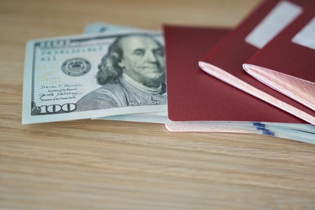 Passport with $100 notes on the table.の写真素材