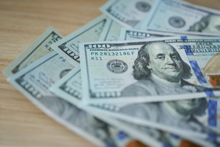 Hundred dollar notes are lying on the table. Selective focus, shallow depth of field.の写真素材
