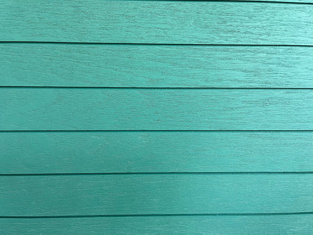 Texture of a wall of wood painted in turquoise color. Pattern of wooden boards.