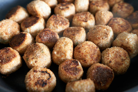 fried meatballs in a frying pan, close-up, macro