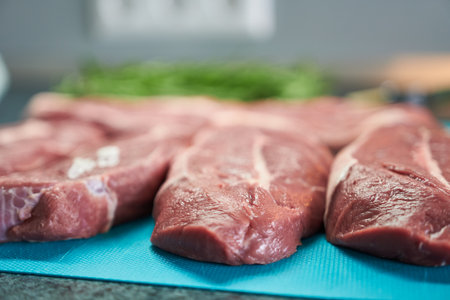Raw beef steaks on a cutting board, ready for cooking. Selective focus.の写真素材