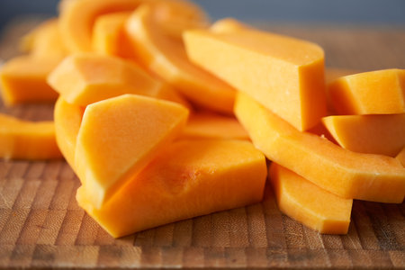 Close-up of sliced ââpumpkin pieces on a cutting board.の写真素材