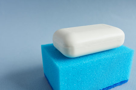 Soap and sponge on a blue background. Close-up.の写真素材