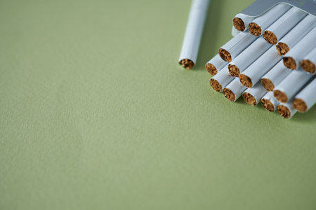 Close-up of cigarettes on green background with copy space. Stop smoking conceptの写真素材