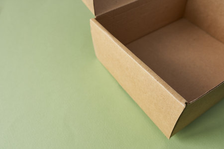 Cardboard box on a green background. Gift box. Copy space for your text.の写真素材