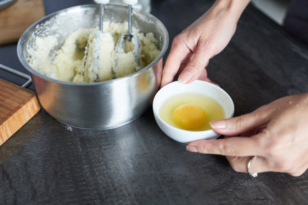Close up of woman's hands kneading dough in the kitchen