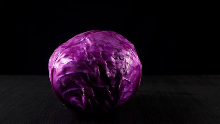 Fresh red cabbage (Brassica oleracea) on black backgroundの写真素材