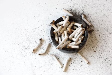 Full ashtray of cigarettes. Smoking is injurious to your health.の写真素材