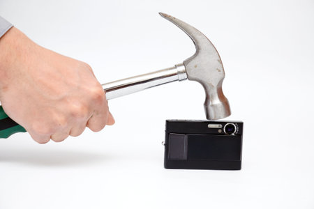 The hammer strikes on the black camera 