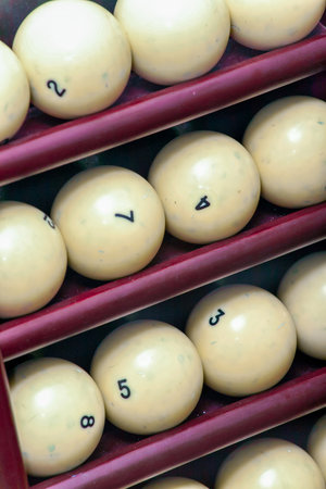 Billiard balls made of ivory on a wooden stockの写真素材
