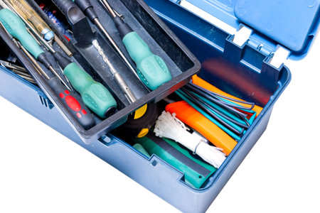 Blue box with tools screwdrivers, hammer, drill, tape measure on white background. Isolated
