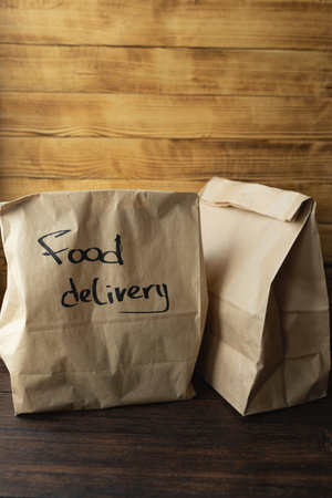 Craft packages with food delivery on dark wooden backgroundの写真素材
